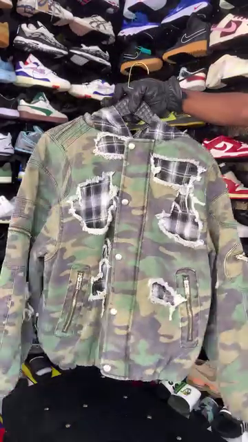 Distressed camouflage bomber jacket